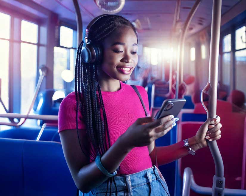 Woman on Bus looking at Phone